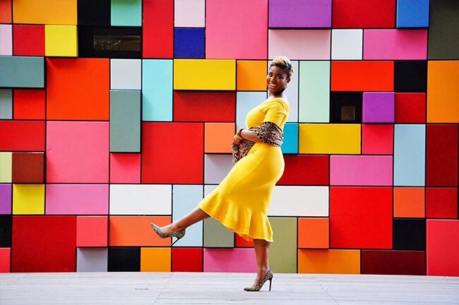 woman in front of colorful wall
